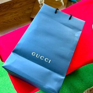 Paper Gift bag Gucci store. White letter on black